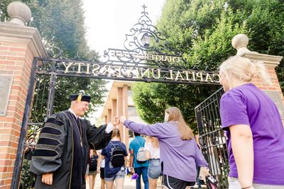 President Kaufman Welcoming Student With Fistbump